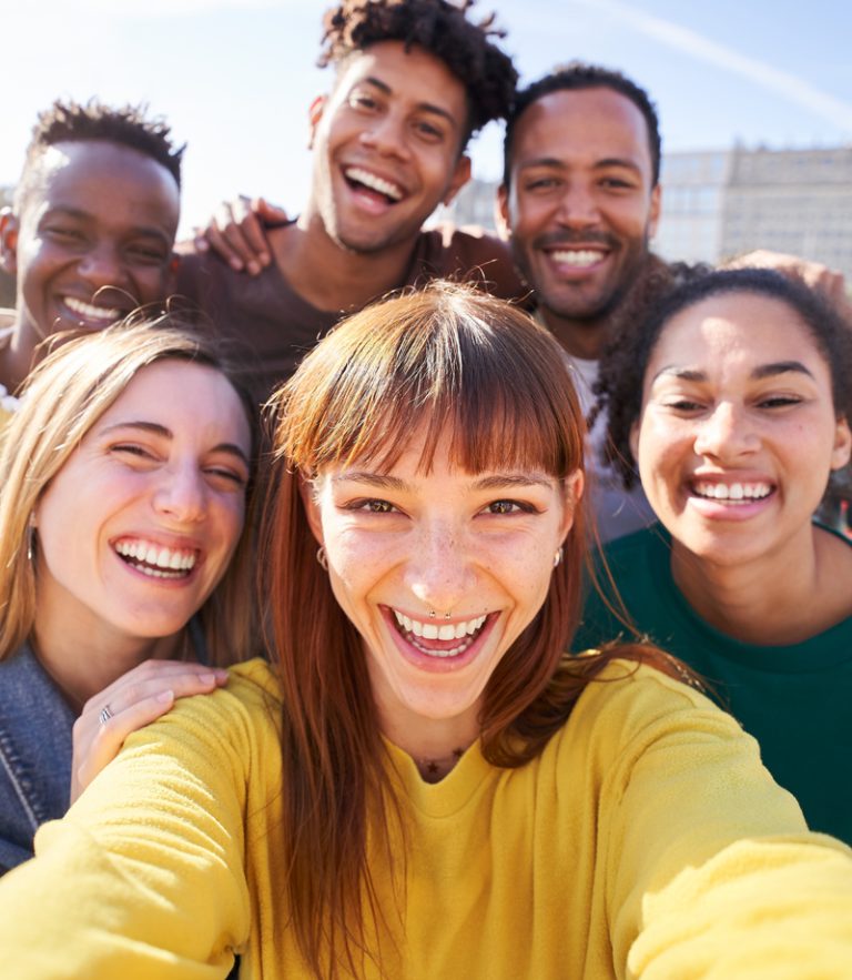 A diverse ministry team in the field laughing and having a good time spreading the word of God