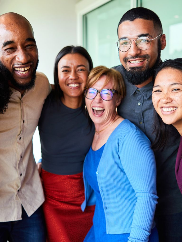 ministry-team-happy-working-with-mcode-coach-img A diverse ministry leadership team is all smiles and laughing after completing a team workshop led by a Certified MCode for Ministry Coach